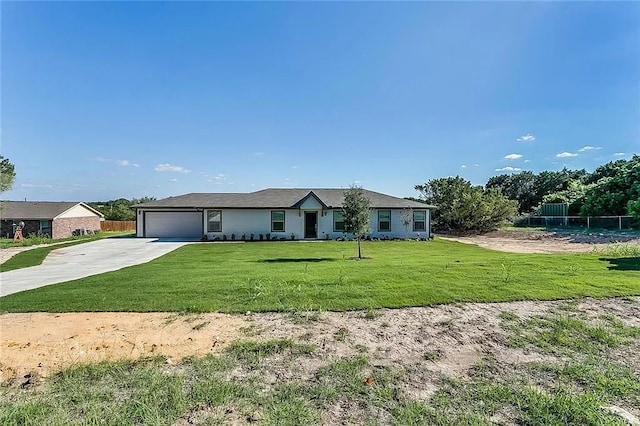 single story home featuring a garage and a front yard