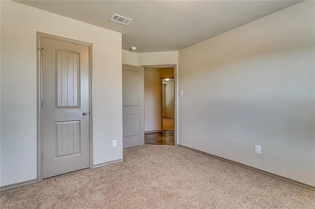 unfurnished bedroom featuring light carpet