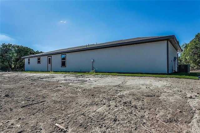 rear view of house featuring central air condition unit