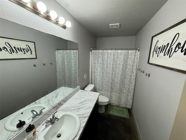 bathroom with toilet, a textured ceiling, walk in shower, and vanity