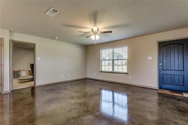 interior space featuring a textured ceiling and ceiling fan