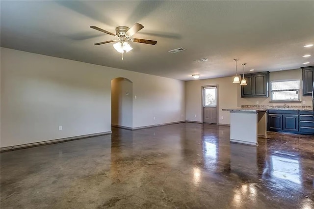 kitchen featuring a kitchen island, ceiling fan, a wealth of natural light, and sink