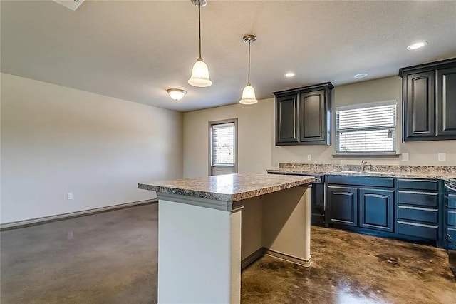 kitchen with sink, a healthy amount of sunlight, a center island, and decorative light fixtures