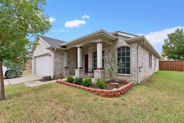 view of front of property featuring covered porch, a front yard, and a garage