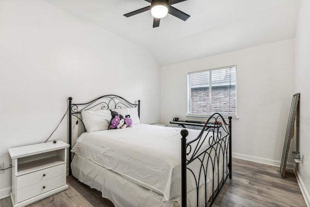 bedroom with hardwood / wood-style flooring, ceiling fan, and lofted ceiling