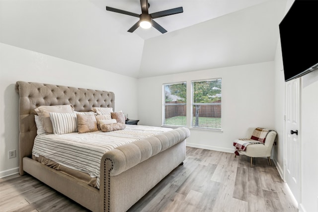 bedroom with light hardwood / wood-style floors, vaulted ceiling, and ceiling fan