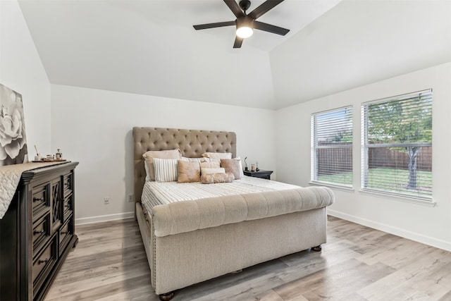 bedroom with ceiling fan, light hardwood / wood-style floors, and lofted ceiling