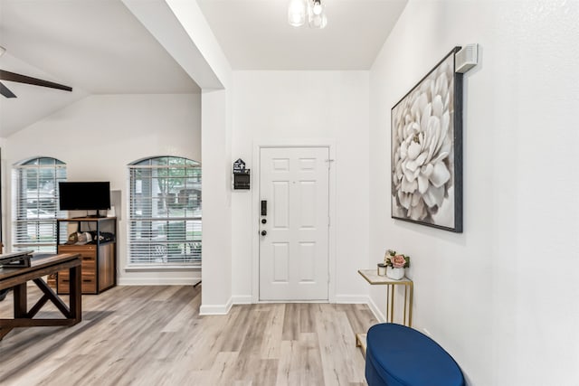 foyer entrance with ceiling fan, light hardwood / wood-style flooring, and lofted ceiling