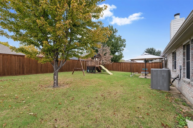 view of yard featuring a gazebo, a playground, and central air condition unit