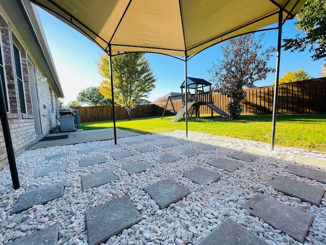 view of patio featuring a playground and a gazebo