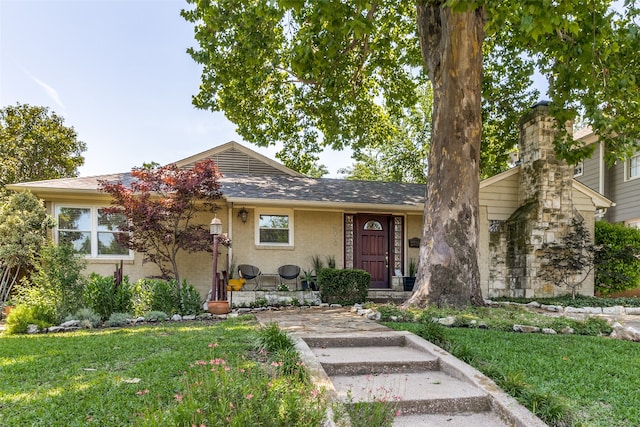 view of front facade with a front yard and covered porch