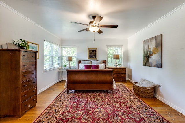 bedroom featuring ceiling fan, light wood-type flooring, and crown molding