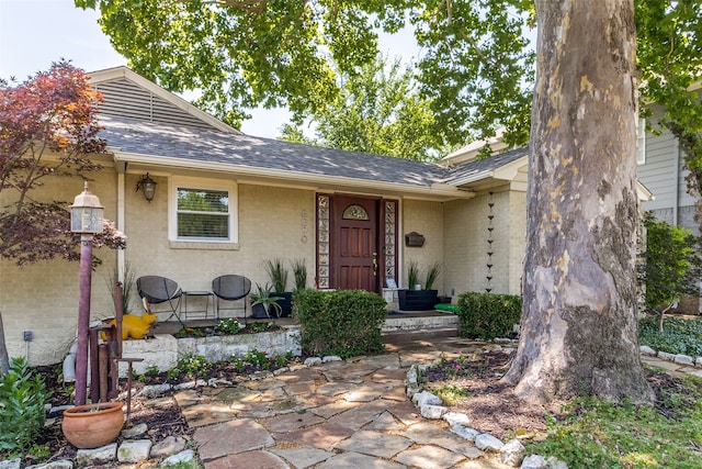 view of exterior entry with covered porch