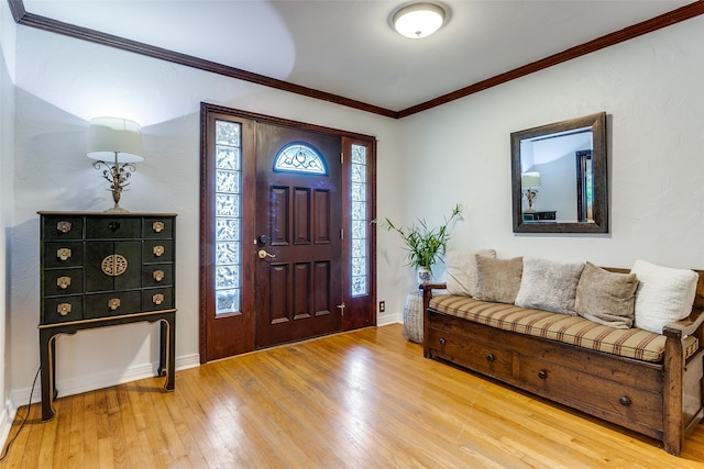 entryway featuring wood-type flooring and ornamental molding