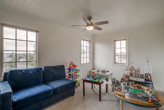 recreation room with carpet, ceiling fan, crown molding, and wooden ceiling