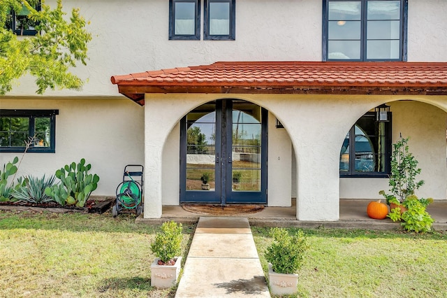 doorway to property with a yard and french doors