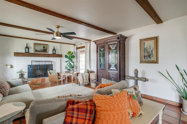 tiled living room with ceiling fan and beam ceiling