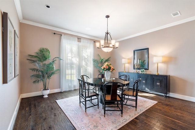 dining area featuring a chandelier, crown molding, and dark hardwood / wood-style flooring