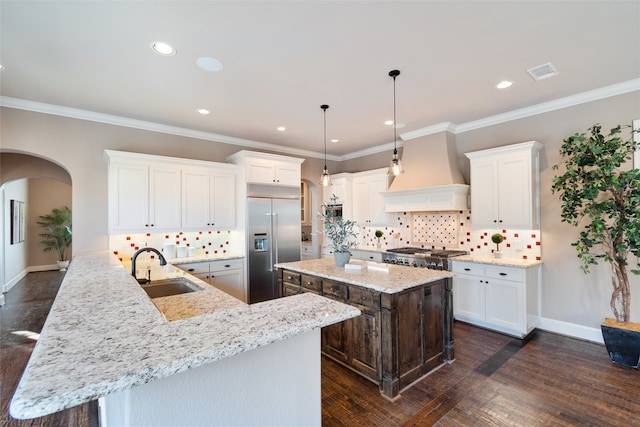 kitchen featuring dark wood-type flooring, kitchen peninsula, sink, appliances with stainless steel finishes, and premium range hood