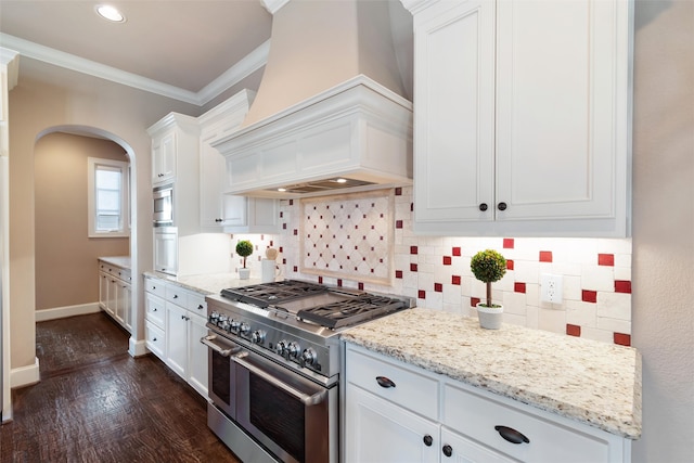 kitchen with double oven range, white cabinetry, premium range hood, and dark hardwood / wood-style flooring