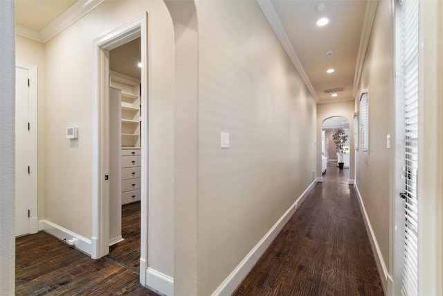 hall with dark hardwood / wood-style flooring and crown molding