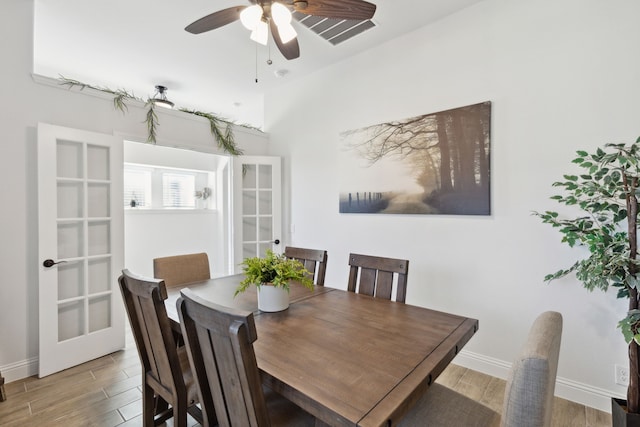 dining room with french doors, ceiling fan, and wood-type flooring