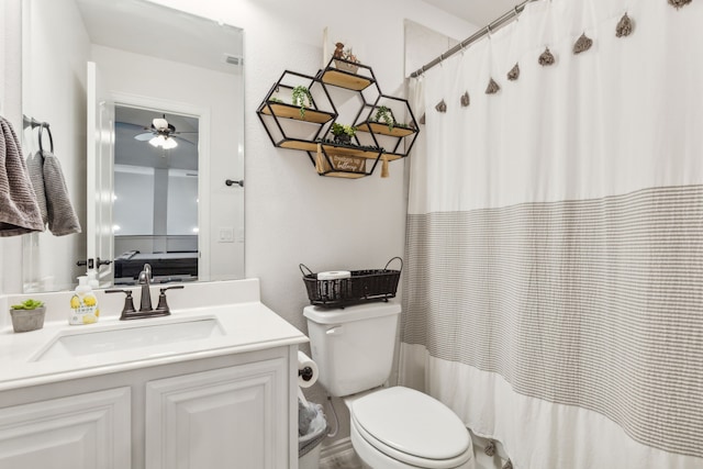 bathroom with toilet, vanity, and ceiling fan