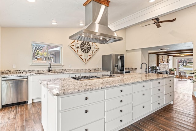 kitchen featuring sink, appliances with stainless steel finishes, white cabinetry, a spacious island, and island range hood