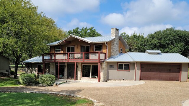 view of front of property with a deck and a garage