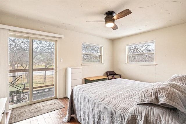 bedroom with access to exterior, ceiling fan, and hardwood / wood-style flooring