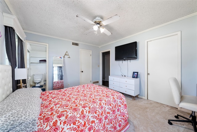 carpeted bedroom featuring ceiling fan, a textured ceiling, connected bathroom, and ornamental molding