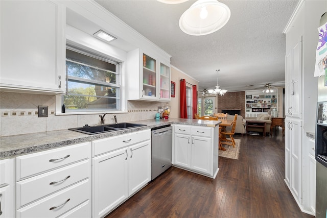 kitchen featuring white cabinetry, hanging light fixtures, sink, dishwasher, and kitchen peninsula