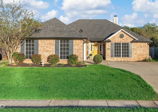 ranch-style house with a front lawn