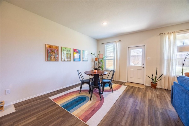 dining space featuring wood finished floors, baseboards, and recessed lighting