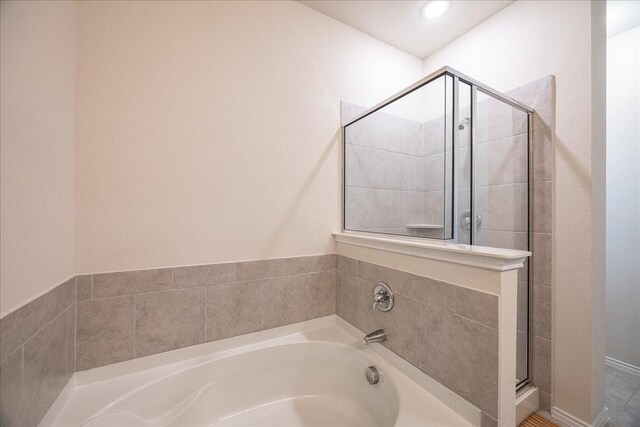 full bath with a shower stall and a garden tub