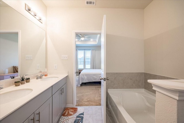 bathroom featuring connected bathroom, double vanity, a bath, tile patterned floors, and ceiling fan