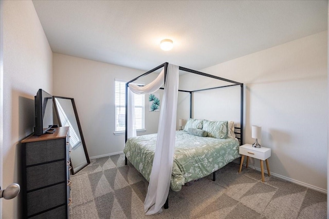 bedroom with carpet floors and baseboards