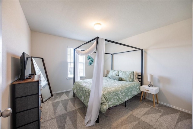 carpeted bedroom featuring baseboards