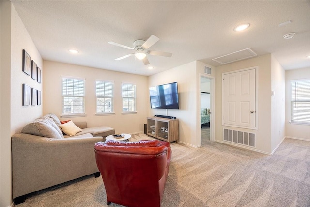 carpeted living area featuring recessed lighting, visible vents, ceiling fan, and baseboards