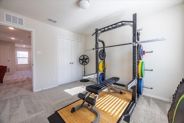 exercise area with baseboards, visible vents, and carpet flooring