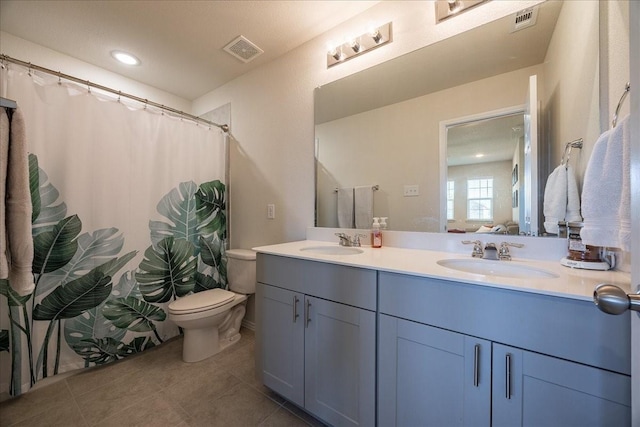 full bathroom featuring tile patterned flooring, toilet, double vanity, recessed lighting, and curtained shower