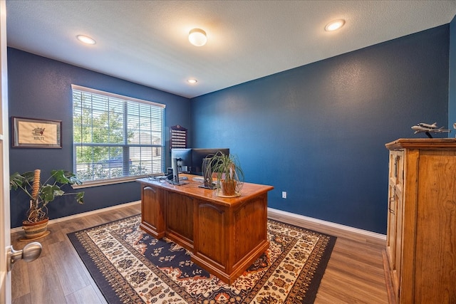 office featuring recessed lighting, wood finished floors, and baseboards