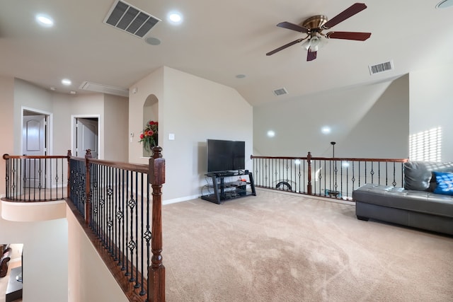 sitting room with ceiling fan, light colored carpet, and lofted ceiling