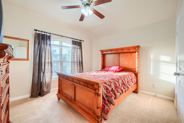 carpeted bedroom with ceiling fan and vaulted ceiling