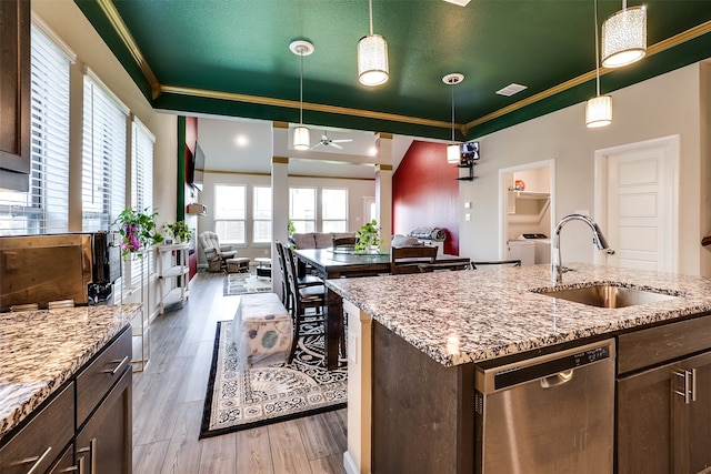 kitchen featuring sink, ceiling fan, stainless steel dishwasher, dark brown cabinets, and light hardwood / wood-style flooring