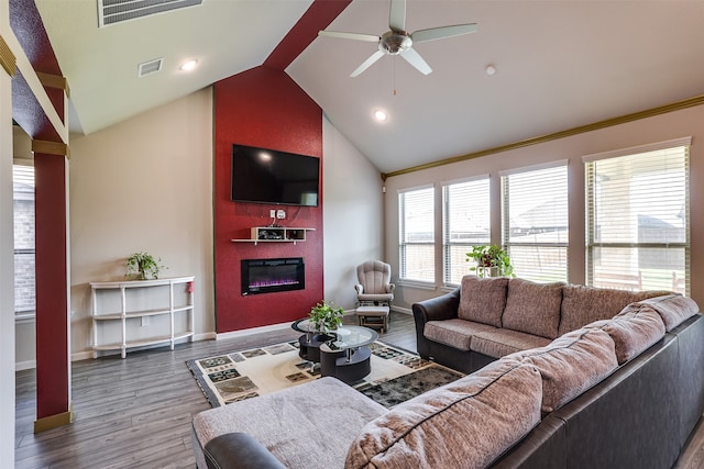 living room with hardwood / wood-style floors, a large fireplace, vaulted ceiling, and ceiling fan