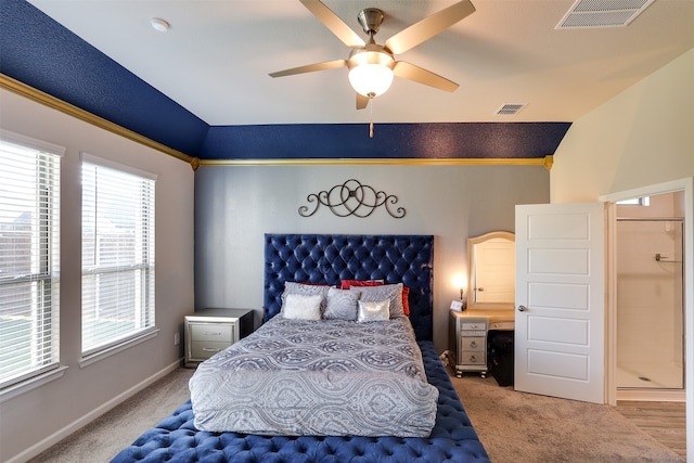 carpeted bedroom with ceiling fan and vaulted ceiling