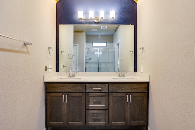 bathroom with vanity and a shower with door