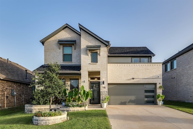 view of front of home with a garage and a front yard