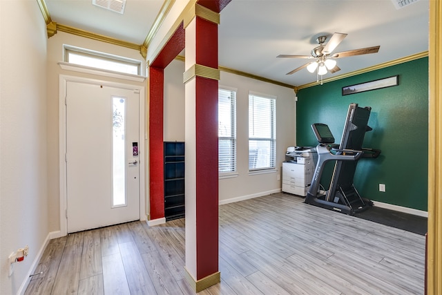 foyer entrance with ceiling fan, crown molding, and light hardwood / wood-style flooring